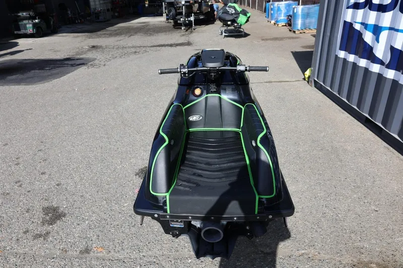 Slide: The Image of 2022 Kawasaki Jetski SX-R with green accents, parked on concrete surface. - 3