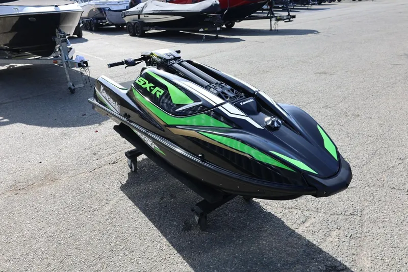 Slide: The Image of 2022 Kawasaki Jetski SX-R in black and green, displayed outdoors on pavement. - 6