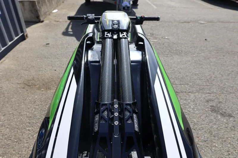 Slide: The Image of 2022 Kawasaki Jetski SX-R, top view, green and black design, parked on pavement. - 7
