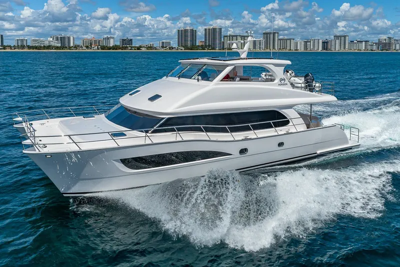 The Image of Luxurious 2023 Horizon PC60 yacht cruising on blue ocean near city skyline. - 1