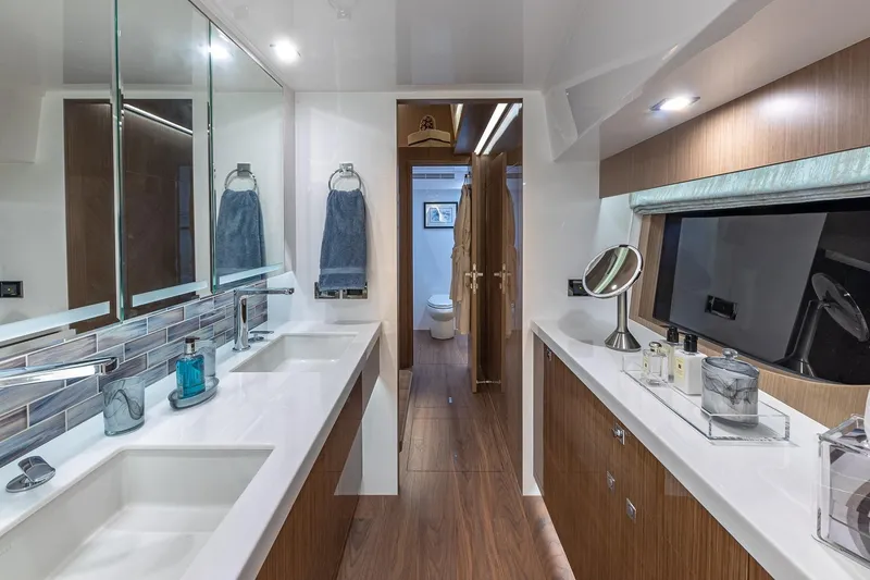 Slide: The Image of Luxurious bathroom in 2023 Horizon PC60 yacht, featuring dual sinks and modern decor. - 14