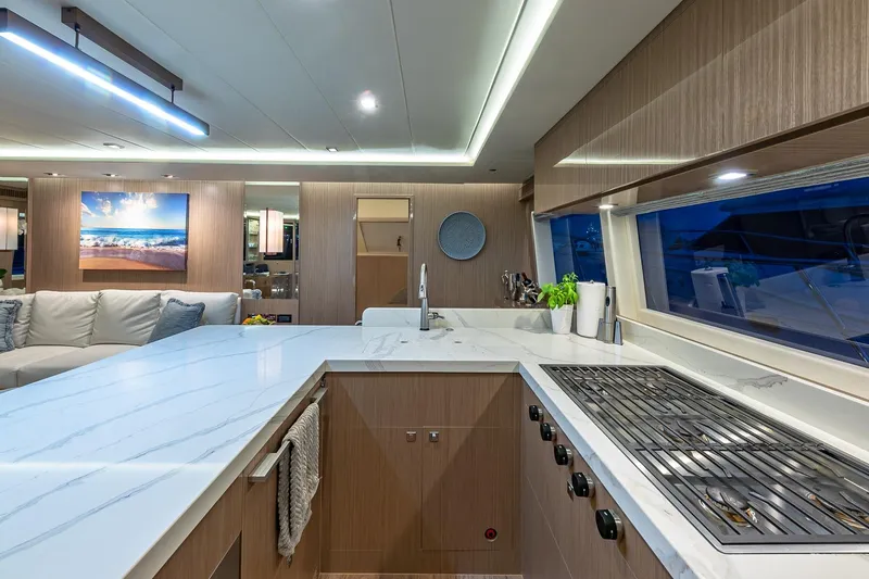 Slide: The Image of Luxurious 2023 Horizon PC60 yacht interior with modern kitchen and elegant design. - 7