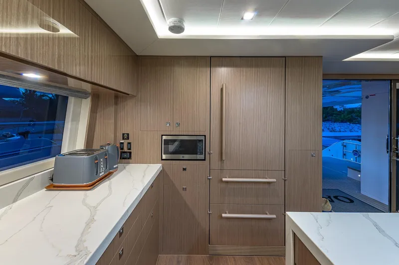 Slide: The Image of Modern yacht kitchen interior with wood paneling, marble countertops, and built-in appliances on Horizon PC60. - 8