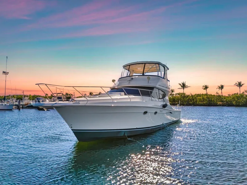 The Image of 2007 Silverton 45 Convertible yacht on serene water at sunset. - 0