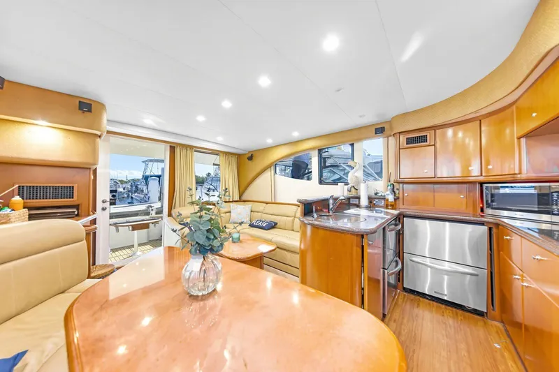 Slide: The Image of Luxurious interior of a 2007 Silverton 45 Convertible yacht with modern kitchen and seating area. - 10