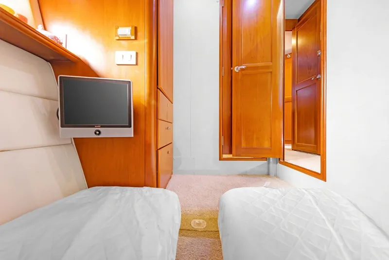 Slide: The Image of Interior of 2007 Silverton 45 Convertible yacht with wood cabinetry and mounted TV. - 12