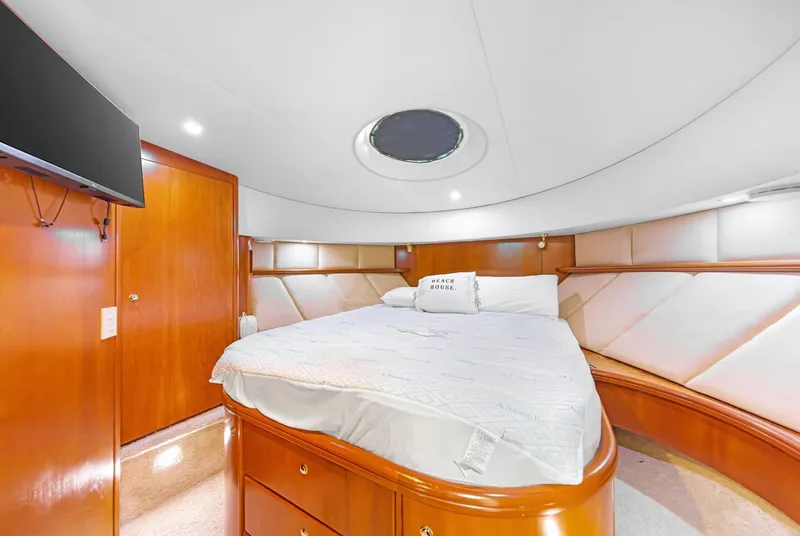Slide: The Image of Luxurious bedroom interior of 2007 Silverton 45 Convertible yacht with elegant wood finishes. - 16