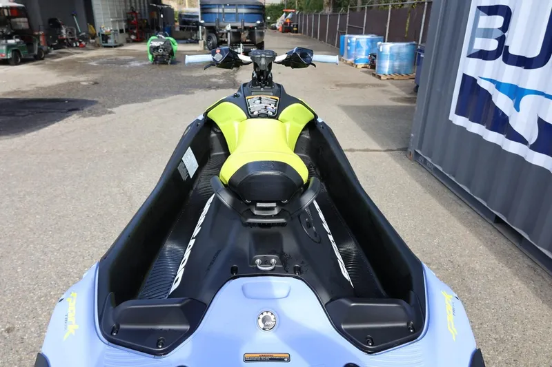 Slide: The Image of 2024 Sea-Doo Spark Trixx jet ski, lime green seat, parked outdoors. - 14