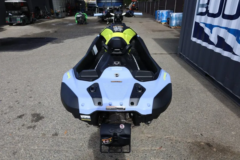 Slide: The Image of 2024 Sea-Doo Spark Trixx for 1, rear view, parked outdoors. - 15