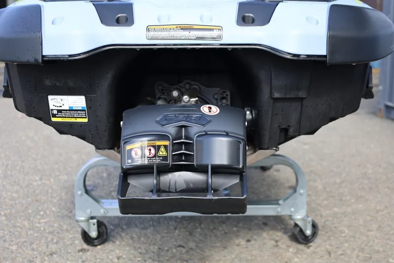 Slide: The Image of 2024 Sea-Doo Spark Trixx rear view, showcasing engine and warning labels. - 6