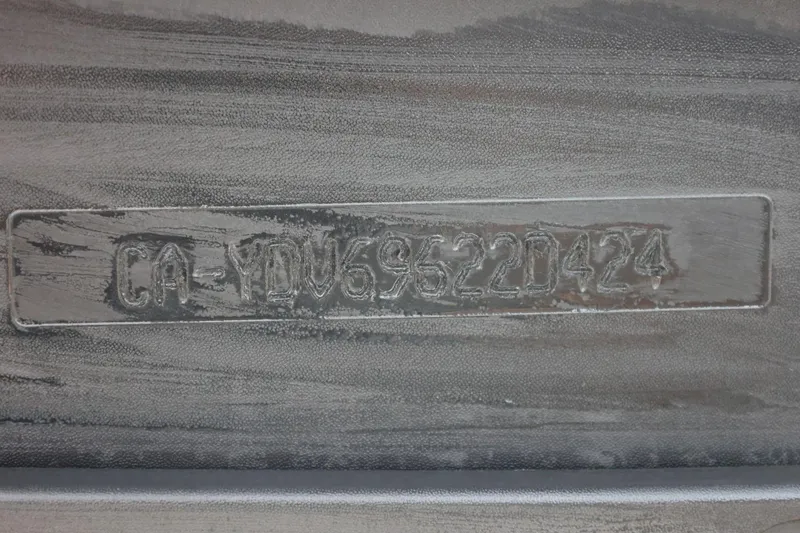 Slide: The Image of 2024 Sea-Doo Spark Trixx hull identification number engraved on metal surface. - 7