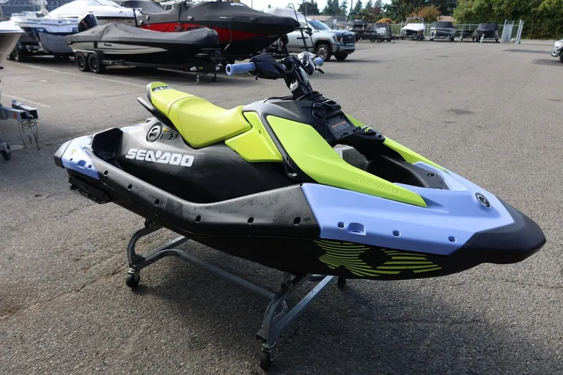 Slide: The Image of 2024 Sea-Doo Spark Trixx for 1, lime green and black, on display outdoors. - 8