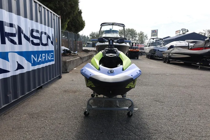 Slide: The Image of 2024 Sea-Doo Spark Trixx for 1 displayed at a marina, surrounded by boats. - 9