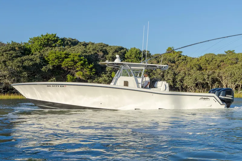 Slide: The Image of 2015 Invincible 39 Open Fisherman boat cruising on calm water. - 10