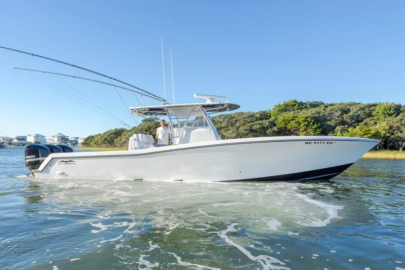 Slide: The Image of 2015 Invincible 39 Open Fisherman boat with triple Yamaha engines on calm water. - 11