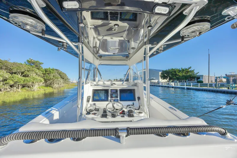 Slide: The Image of 2015 Invincible 39 Open Fisherman boat cockpit with navigation screens and controls. - 21