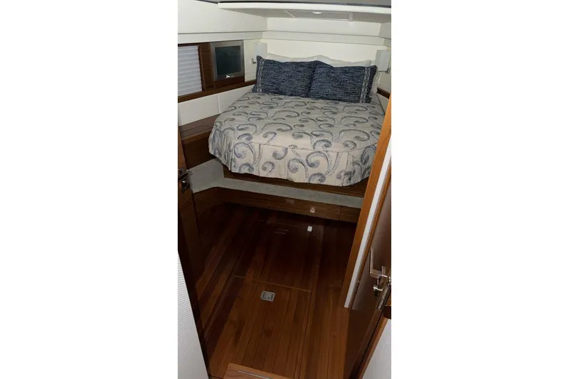 Slide: The Image of Interior cabin of 2018 Tiara Yachts C44 Coupe with bed and wooden flooring. - 17