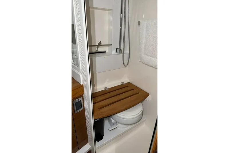 Slide: The Image of 2018 Tiara Yachts C44 Coupe bathroom with wooden seat and modern fixtures. - 19