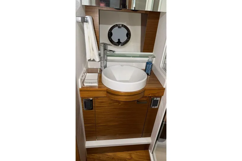 Slide: The Image of 2018 Tiara Yachts C44 Coupe bathroom with modern sink and wooden cabinetry. - 20