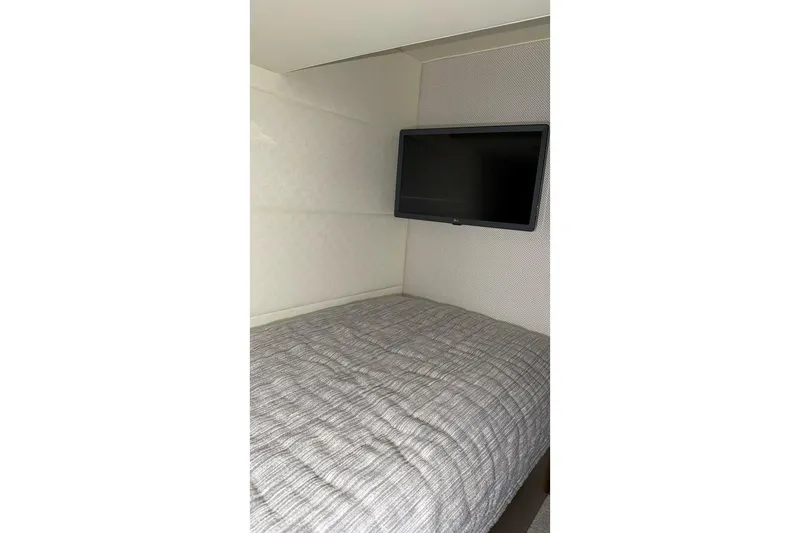 Slide: The Image of Interior cabin of 2018 Tiara Yachts C44 Coupe with bed and wall-mounted TV. - 22
