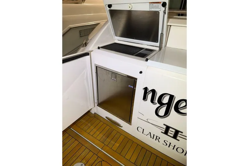 Slide: The Image of 2018 Tiara Yachts C44 Coupe deck with storage compartments and teak flooring. - 24
