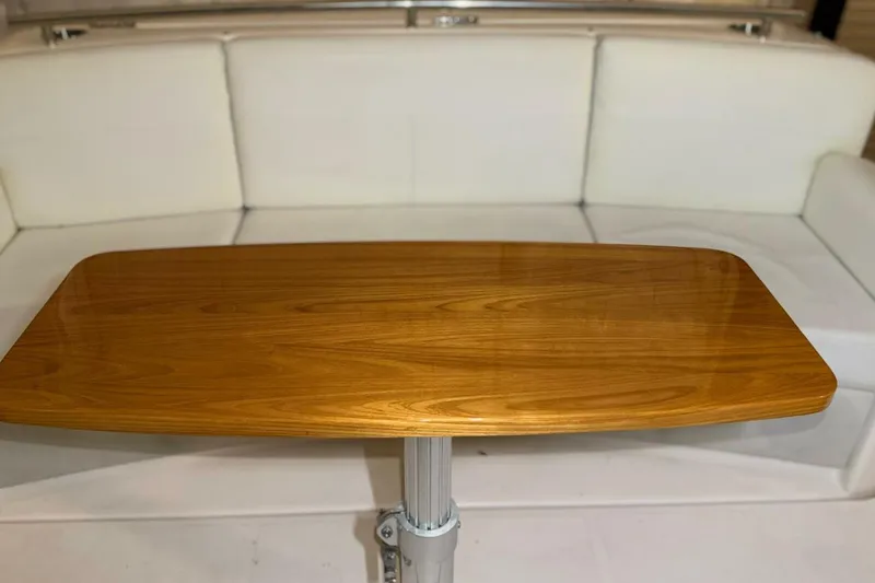 Slide: The Image of Wooden table on 2018 Tiara Yachts C44 Coupe, with white seating background. - 26