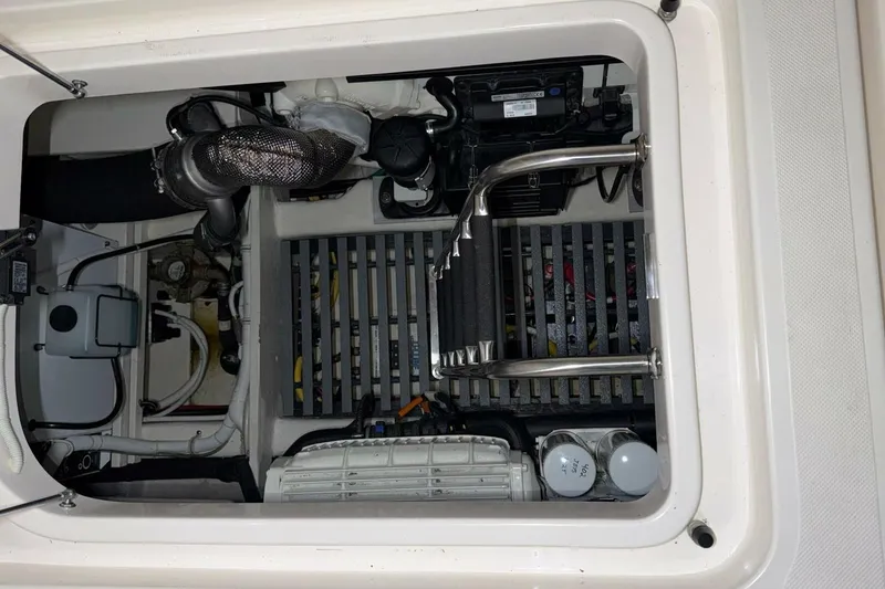 Slide: The Image of Engine compartment of a 2018 Tiara Yachts C44 Coupe, showcasing mechanical components and wiring. - 33