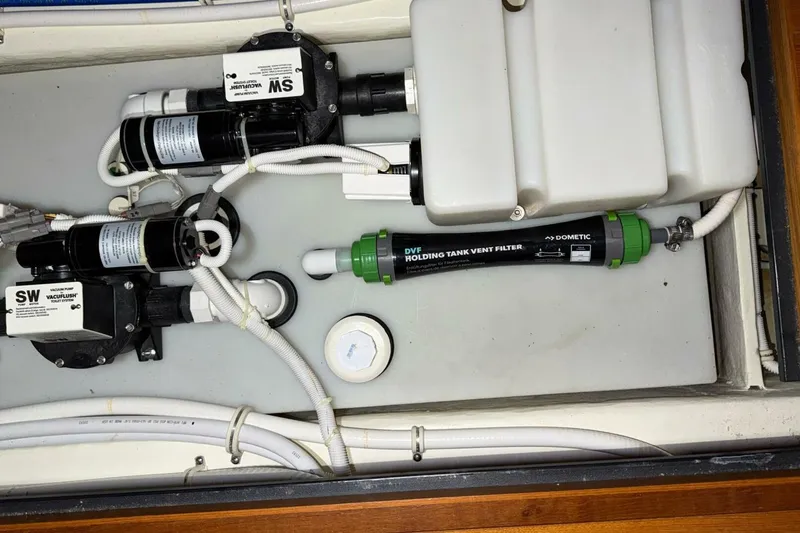 Slide: The Image of 2018 Tiara Yachts C44 Coupe plumbing system with vacuum pump and holding tank vent filter. - 34