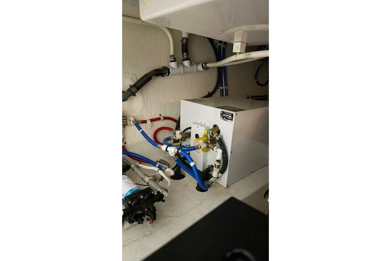 Slide: The Image of Engine room of 2018 Tiara Yachts C44 Coupe with visible plumbing and equipment. - 39