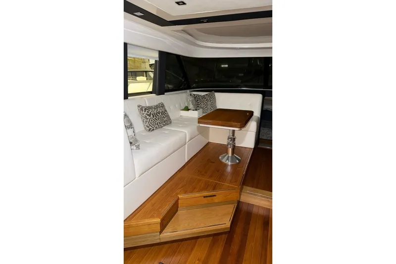 Slide: The Image of Luxurious interior of 2018 Tiara Yachts C44 Coupe with elegant seating and wooden table. - 6