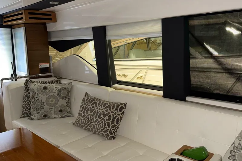 Slide: The Image of Interior of 2018 Tiara Yachts C44 Coupe with elegant seating and decorative pillows. - 7