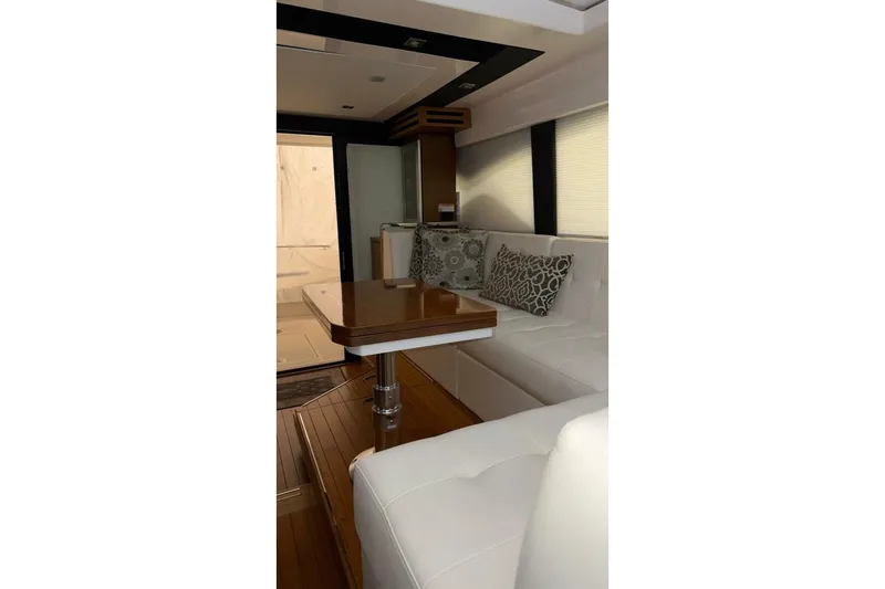 Slide: The Image of Luxurious interior of 2018 Tiara Yachts C44 Coupe with elegant seating and wooden table. - 8