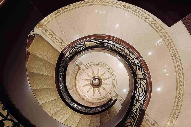 Slide: The Image of Elegant spiral staircase on 2003 Trinity Yachts motoryacht, featuring intricate railing and marble design. - 11