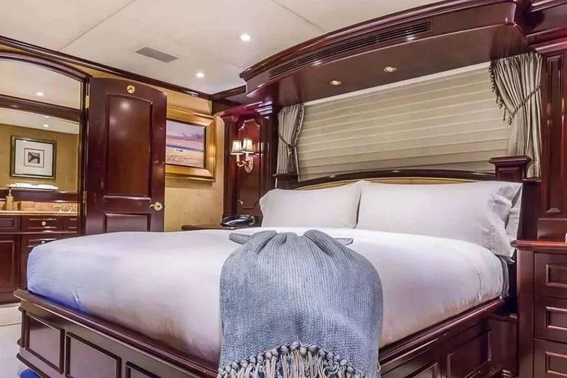 Slide: The Image of Luxurious bedroom interior on 2003 Trinity Yachts motoryacht with elegant wood finishes. - 13