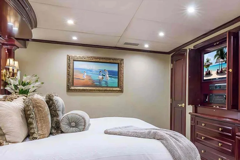 Slide: The Image of Luxurious bedroom interior on 2003 Trinity Yachts motoryacht, featuring elegant decor and entertainment system. - 14