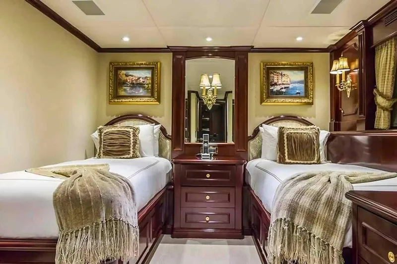 Slide: The Image of Luxurious 2003 Trinity Yachts motoryacht bedroom with twin beds, elegant decor, and framed artwork. - 15