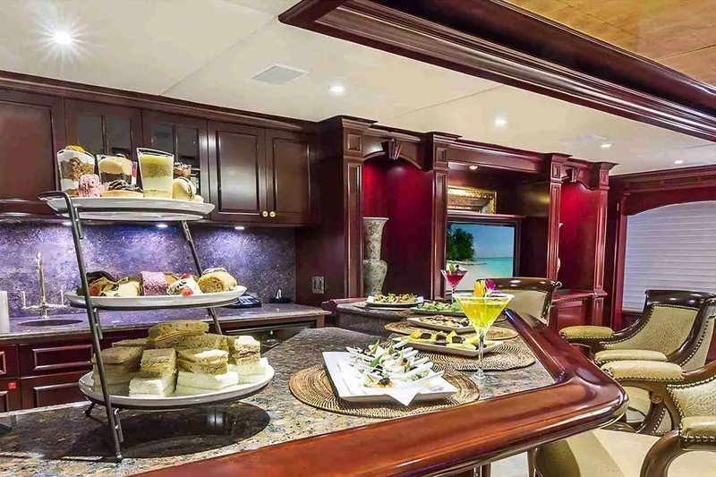 Slide: The Image of Luxurious interior of 2003 Trinity Yachts motoryacht with elegant dining setup and rich wood finishes. - 19