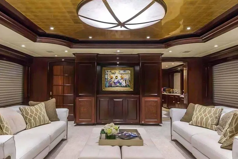 Slide: The Image of Luxurious 2003 Trinity Yachts motoryacht interior with elegant wood paneling and plush seating. - 2