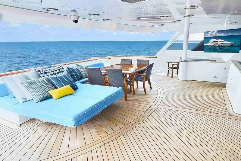 Slide: The Image of Luxurious 2003 Trinity Yachts motoryacht deck with seating, dining area, and ocean view. - 23