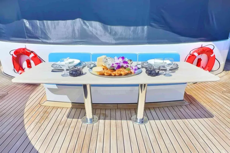 Slide: The Image of Luxurious dining setup on 2003 Trinity Yachts motoryacht deck with elegant tableware. - 25
