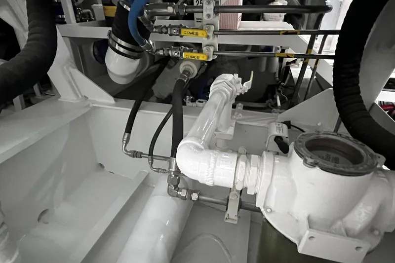 Slide: The Image of Engine room of 2003 Trinity Yachts Motoryacht, showcasing pipes and mechanical components. - 35