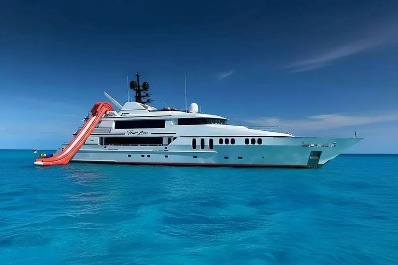 Slide: The Image of Luxurious 2003 Trinity Yachts motoryacht with waterslide, anchored in clear blue ocean. - 37