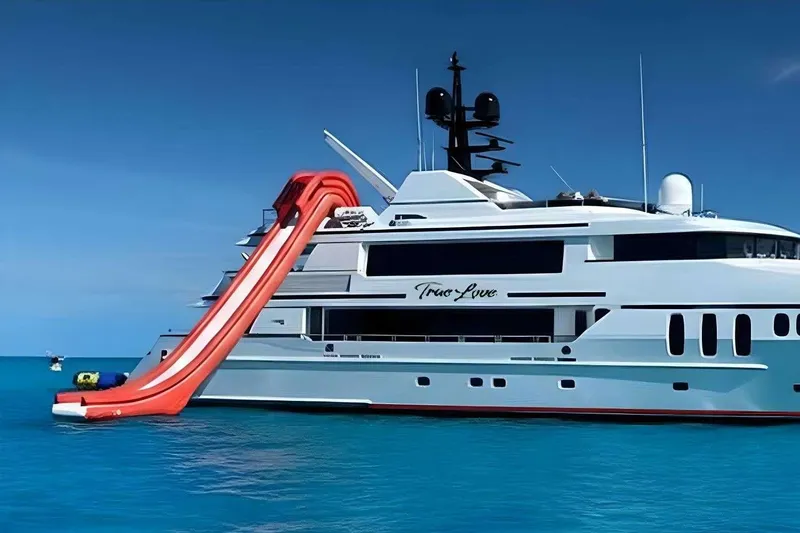 Slide: The Image of Luxurious 2003 Trinity Yachts motoryacht with a red waterslide in turquoise waters. - 38