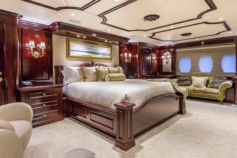 Slide: The Image of Luxurious bedroom interior on 2003 Trinity Yachts motoryacht, featuring elegant wood finishes and plush furnishings. - 7