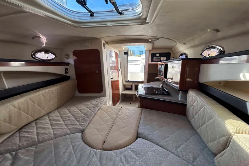 Slide: The Image of Interior of 2007 Sea Ray 260 Sundancer boat with cozy seating and kitchenette. - 11