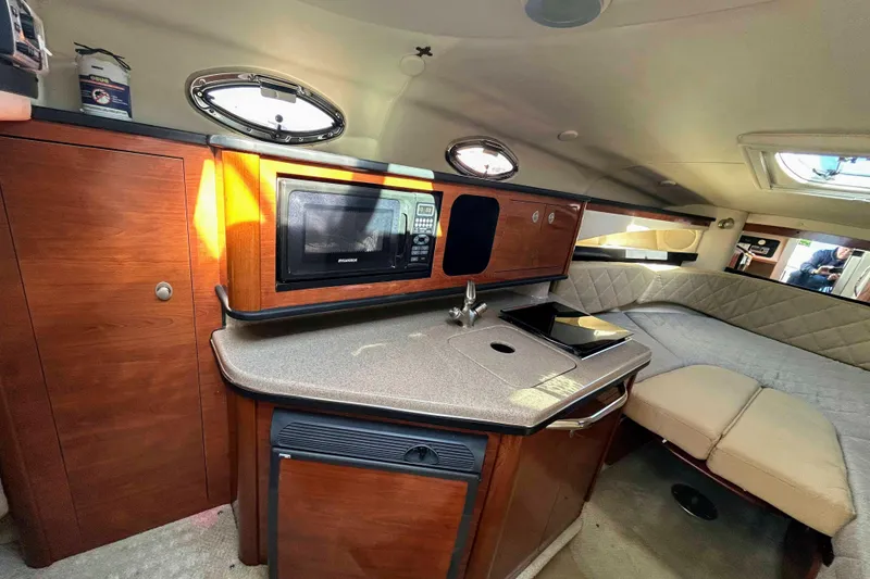 Slide: The Image of 2007 Sea Ray 260 Sundancer cabin with kitchenette and seating area. - 15
