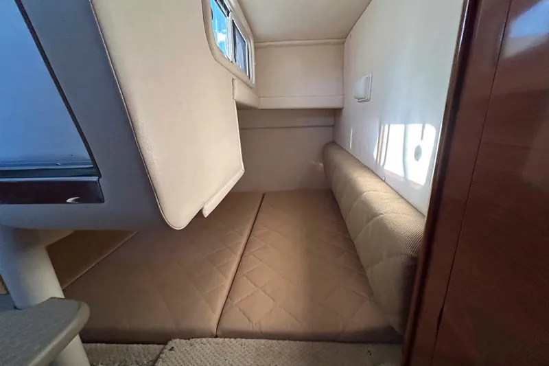 Slide: The Image of 2007 Sea Ray 260 Sundancer cabin interior with cushioned seating and window. - 16