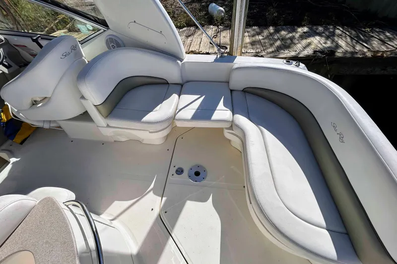 Slide: The Image of 2007 Sea Ray 260 Sundancer boat interior with white cushioned seating. - 4