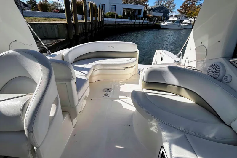 Slide: The Image of 2007 Sea Ray 260 Sundancer boat interior with white seating and waterfront view. - 5