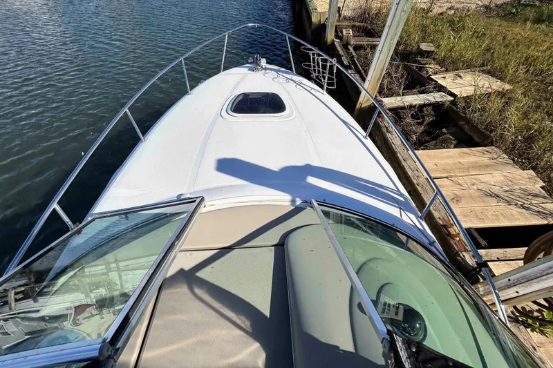 Slide: The Image of 2007 Sea Ray 260 Sundancer boat docked by wooden pier. - 7